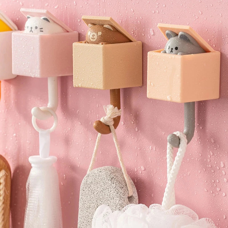 crochets muraux adhésifs en silicone en forme d’animaux mignons- vue l'ouverture du haut avec la tete de l'animal qui sort dès qu'on accroche quelque chose